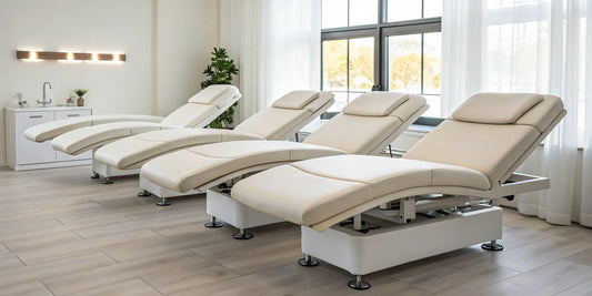 Four modern electric esthetician beds with ergonomic and adjustable features in a spa.
