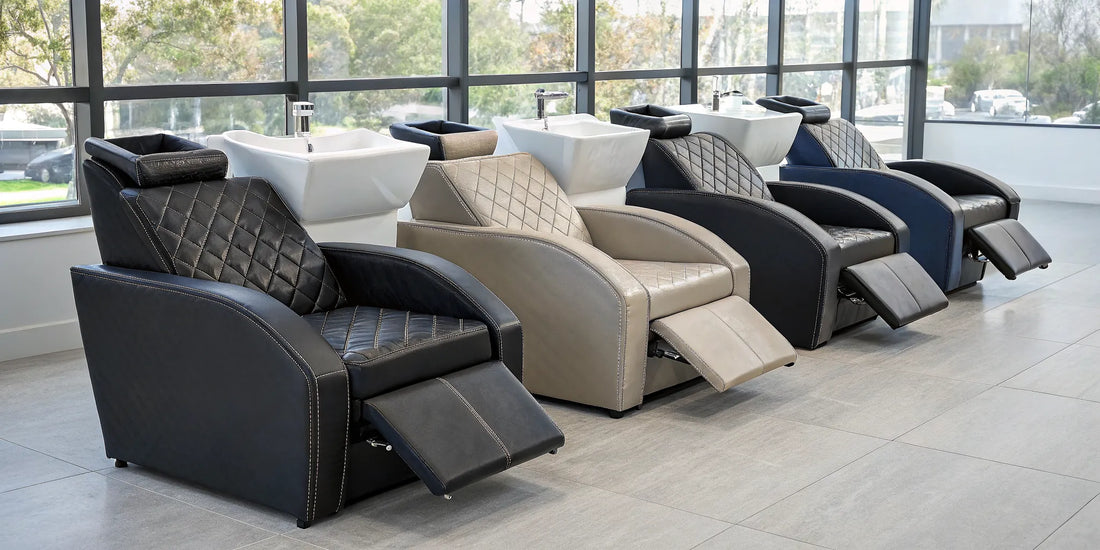 Row of reclining shampoo chairs with footrests in a modern salon.