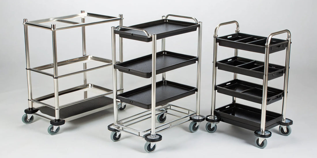 A lineup of professional rolling salon trays with wheels and storage shelves.