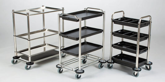 A lineup of professional rolling salon trays with wheels and storage shelves.