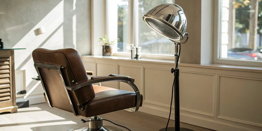 A professional salon standing hair dryer next to a styling chair.