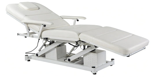 Adjustable electric hydraulic facial bed with plush padding for professional spa use.