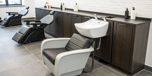 Modern hair washing sink with a black chair and cabinetry for a professional salon.