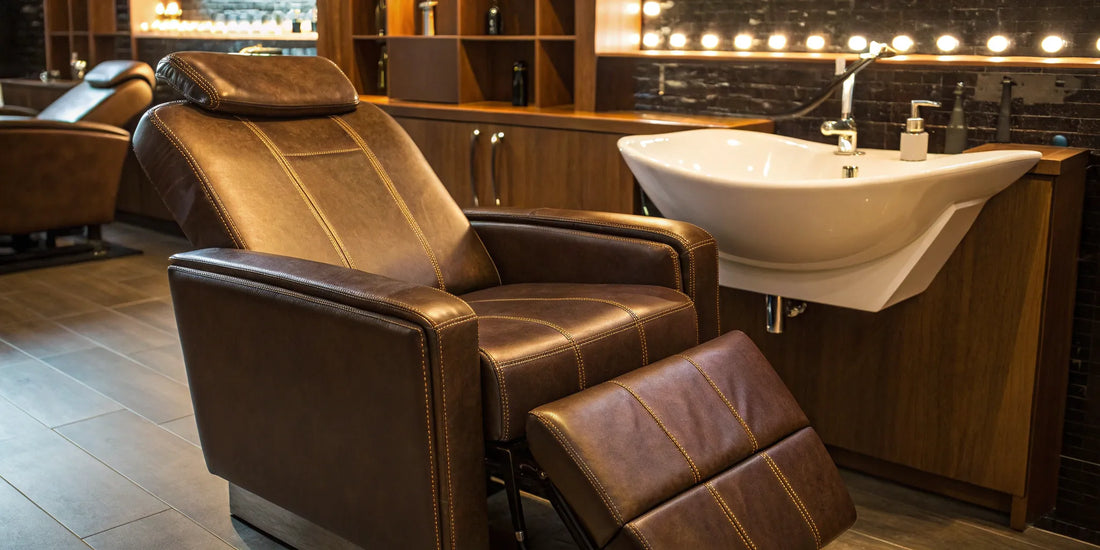 A comfortable reclining shampoo chair with a deep wash basin and brown upholstery in a modern salon.